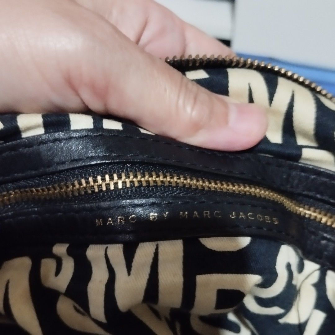 Marc by Marc Jacobs Black Suede Handbag (Category: Luxury Bags & Wallets) located in Manila. Submitted by lene48 (Listing ID 1467729977, Image 3). Description: - Brand: Marc by Marc Jacobs - Material: Black suede exterior with signature B&W logo fabric lining - Hardware: Gold-tone - Compartments: Spacious interior with front turn-lock pocket - Straps: Dual leather top handles and adjustable shoulder strap - Origin: Made in Indonesia - Inclusion: 