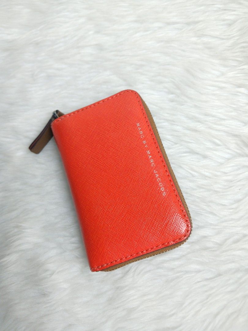 Marc by Marc Jacobs thrift wallet (Category: Wallets & Card holders) located in Cagayan de Oro. Submitted by f.closet. (Listing ID 1467663626, Image 1). Description: Brand: Marc by Marc Jacobs Material: Saffiano leather in bright orange/brown (two colors) Closure: Zip closure leather pull tab Size: perfect for smaller bags Condition: Good to excellent manage your expectations item is thrift.