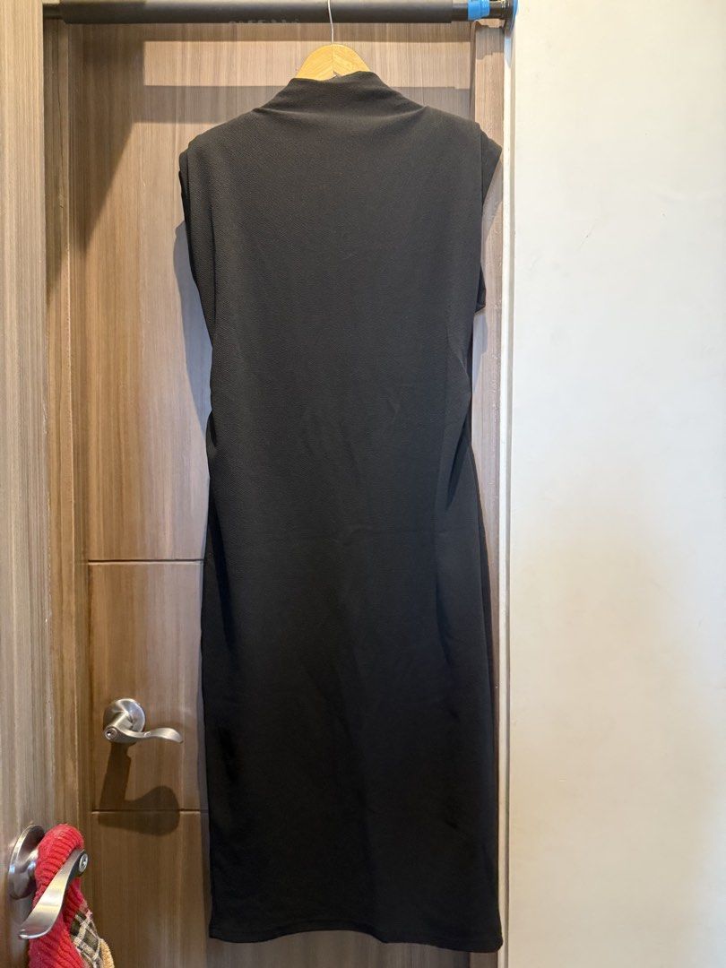 Maternity Dress for Work (Category: Dresses) located in Taguig. Submitted by laramagbalana (Listing ID 1467639968, Image 2). Description: - Style: Black midi dress with a straight silhouette - Details: Padded shoulders, mock neckline, and sleeveless cut - Length: Falls below the knee - Fabric: Textured, stretchy, and comfortable material - Versatility: Solid black color makes it easy to style for casual or formal events SUPER PRETTY WORN ONCE.