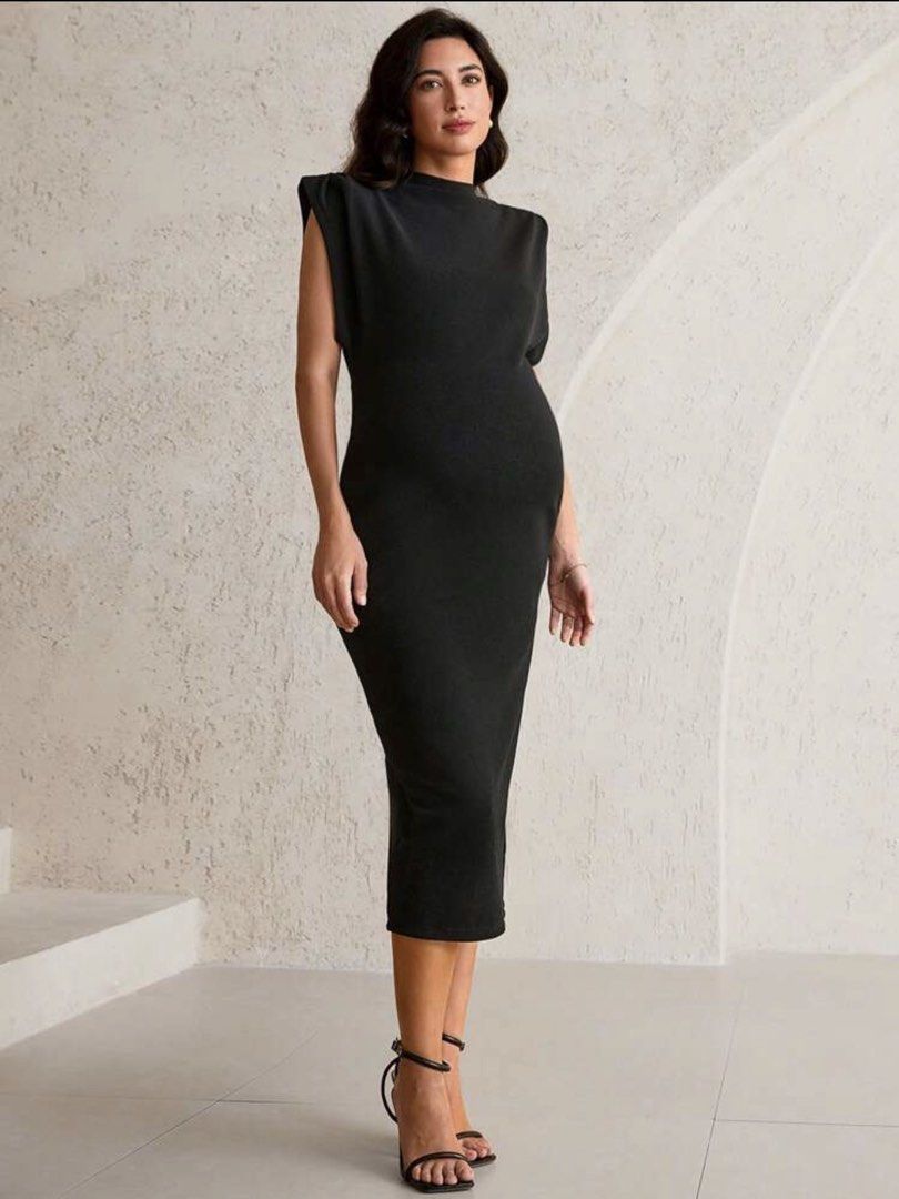 Maternity Dress for Work (Category: Dresses) located in Taguig. Submitted by laramagbalana (Listing ID 1467639968, Image 1). Description: - Style: Black midi dress with a straight silhouette - Details: Padded shoulders, mock neckline, and sleeveless cut - Length: Falls below the knee - Fabric: Textured, stretchy, and comfortable material - Versatility: Solid black color makes it easy to style for casual or formal events SUPER PRETTY WORN ONCE.