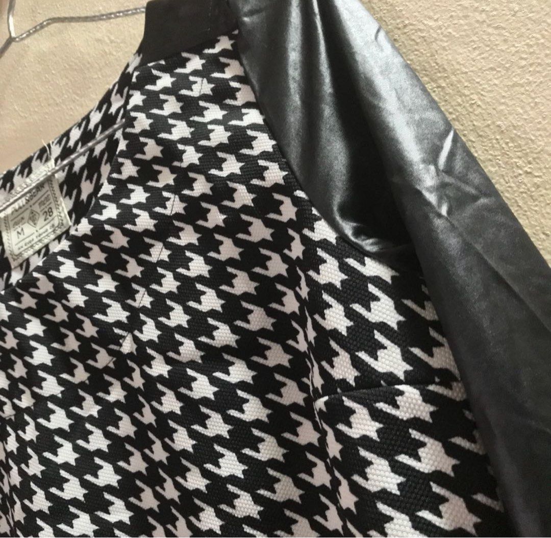 Medium Pull&Bear Houndstooth Top with Faux Leather Sleeves (Category: Blouses) located in Marikina City. Submitted by lovegoeson (Listing ID 1467608280, Image 2). Description: - Brand: Pull&Bear - Size: M (fits true to size) - Design: Classic black and white houndstooth body with long black faux leather sleeves - Neckline: Round neck - Fabric: Comfortable textured material - Styling: Easy to match with jeans or skirts for casual or edgy outfits -