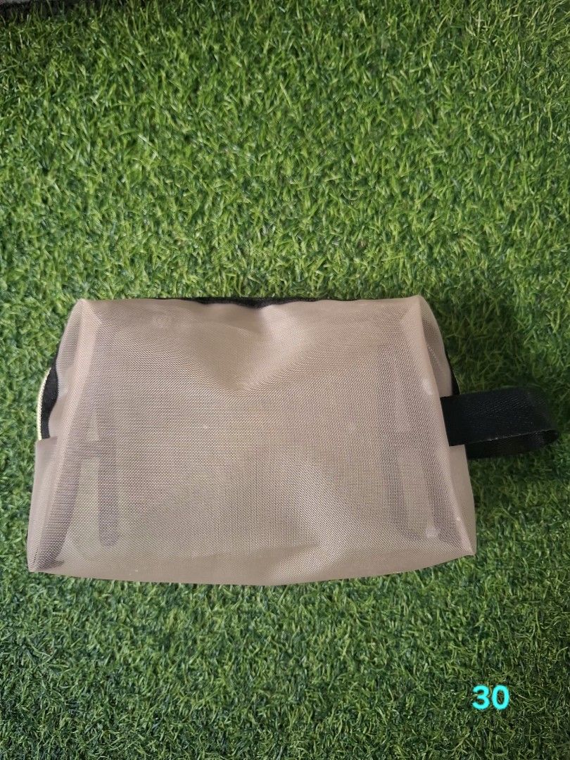 Mesh Cosmetic Pouch Toiletry Bag with Handle (Category: Purses & Pouches) located in Pasay City. Submitted by emilia1102 (Listing ID 1467798654, Image 1). Description: - Color: Neutral beige with black handle and zipper - Material: Semi-transparent mesh for easy item spotting - Design: Roomy main compartment with structured shape - Versatile: Perfect for daily cosmetics, toiletries, or travel essentials - Portable: Compact size that easily fits i