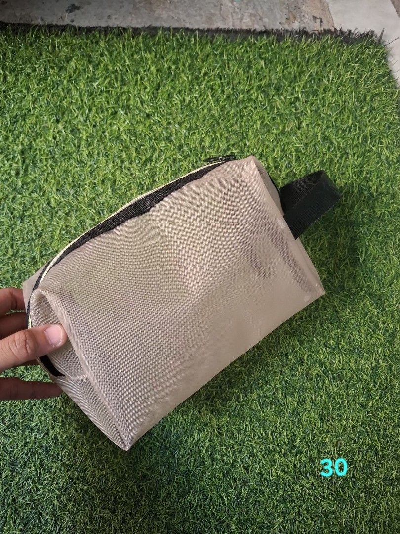 Mesh Cosmetic Pouch Toiletry Bag with Handle (Category: Purses & Pouches) located in Pasay City. Submitted by emilia1102 (Listing ID 1467798654, Image 2). Description: - Color: Neutral beige with black handle and zipper - Material: Semi-transparent mesh for easy item spotting - Design: Roomy main compartment with structured shape - Versatile: Perfect for daily cosmetics, toiletries, or travel essentials - Portable: Compact size that easily fits i