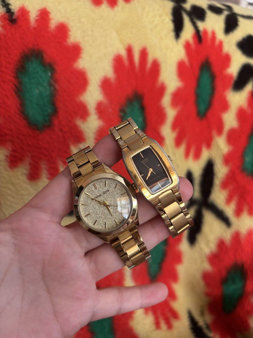 Michael Kors and Casio Gold Watch Bundle (Category: Women's Watches) located in Manila. Submitted by tiffanyyyy09 (Listing ID 1467742882, Image 2). Description: - 2-in-1 gold-tone watch bundle - 1st watch: Michael Kors round face with textured glitter dial - 2nd watch: Casio rectangular face with black dial and stainless steel back - Both feature link bracelets with standard deployment clasps - Condition: Visible surface wear and scuffs on both b