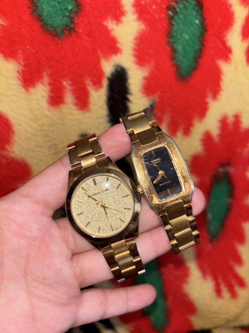 Michael Kors and Casio Gold Watch Bundle (Category: Women's Watches) located in Manila. Submitted by tiffanyyyy09 (Listing ID 1467742882, Image 1). Description: - 2-in-1 gold-tone watch bundle - 1st watch: Michael Kors round face with textured glitter dial - 2nd watch: Casio rectangular face with black dial and stainless steel back - Both feature link bracelets with standard deployment clasps - Condition: Visible surface wear and scuffs on both b