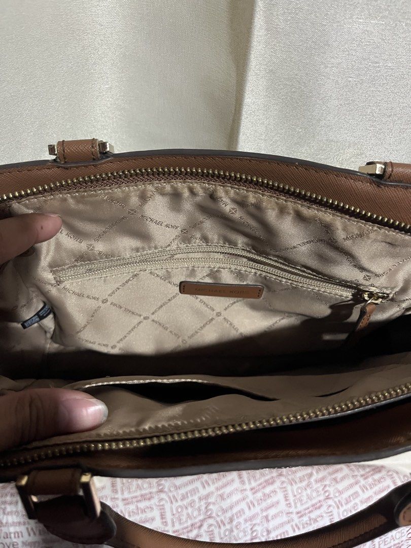 Michael Kors Hope medium messenger satchel bag (Category: Tote Bags) located in Davao. Submitted by daveespino81318 (Listing ID 1467669922, Image 3). Description: Michael Kors Hope medium messenger satchel bag in classic brown signature monogram coated canvas. Condition: Good pre-owned condition with minor signs of wear. Issue: see last pictures Location: Davao City Jnt courier.