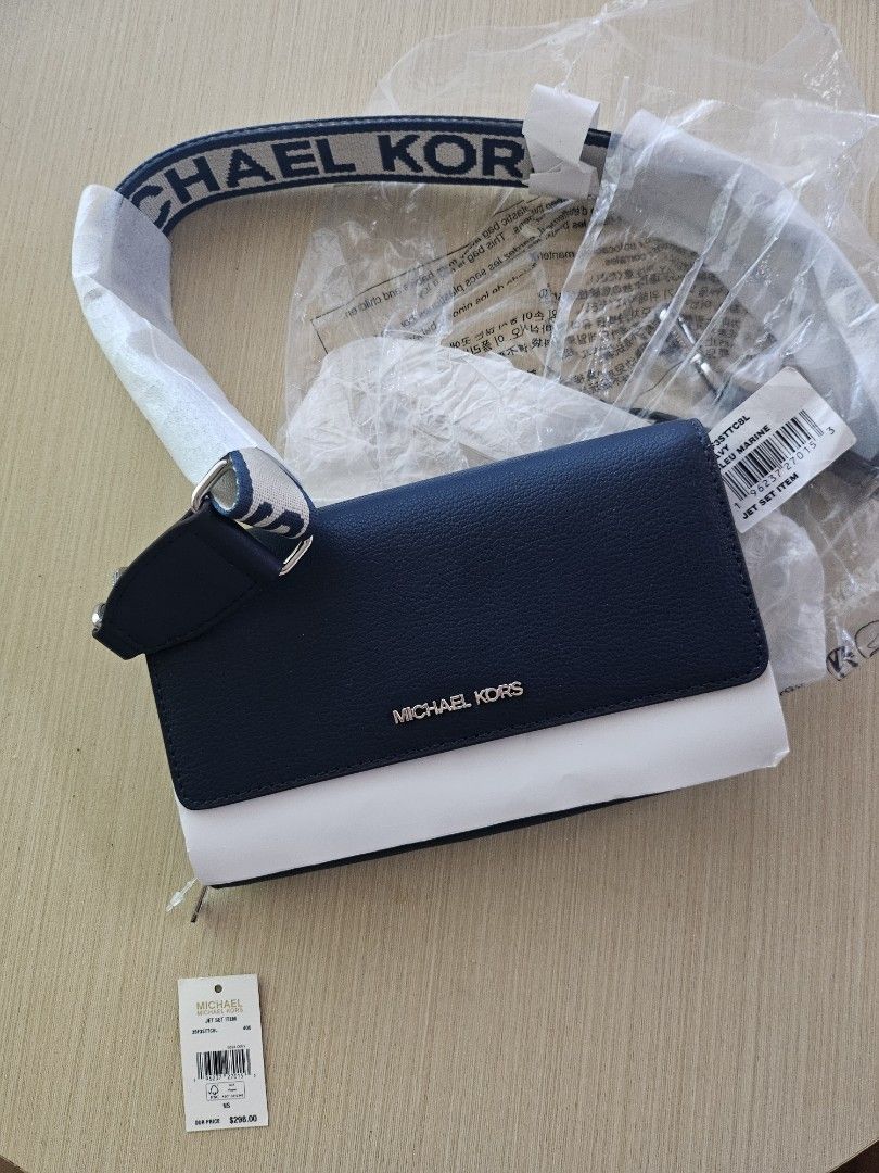 Michael Kors Jet Set Navy Crossbody Bag (Category: Cross-body Bags) located in Dasmarinas. Submitted by klasique.luxxe (Listing ID 1467703607, Image 2). Description: - Brand: Michael Kors Jet Set Crossbody - Color: Navy and White with chunky logo strap - Condition: Brand new, never used, still wrapped in plastic with original tags attached - Proof of Authenticity: Outlet store receipt included.
