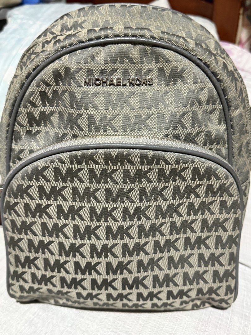 Michael Kors MK Logo Print Gray Backpack (Category: Backpacks) located in Manila. Submitted by devorahlop39116 (Listing ID 1467748470, Image 1). Description: - Authentic Michael Kors backpack in classic gray MK monogram pattern - Structured design with a convenient front zip pocket and sturdy shoulder straps - Clean branded fabric interior with slip pockets, a zip pocket, and leather logo patch - Made in Cambodia - Style code: 35T9SAYB2J - Excell