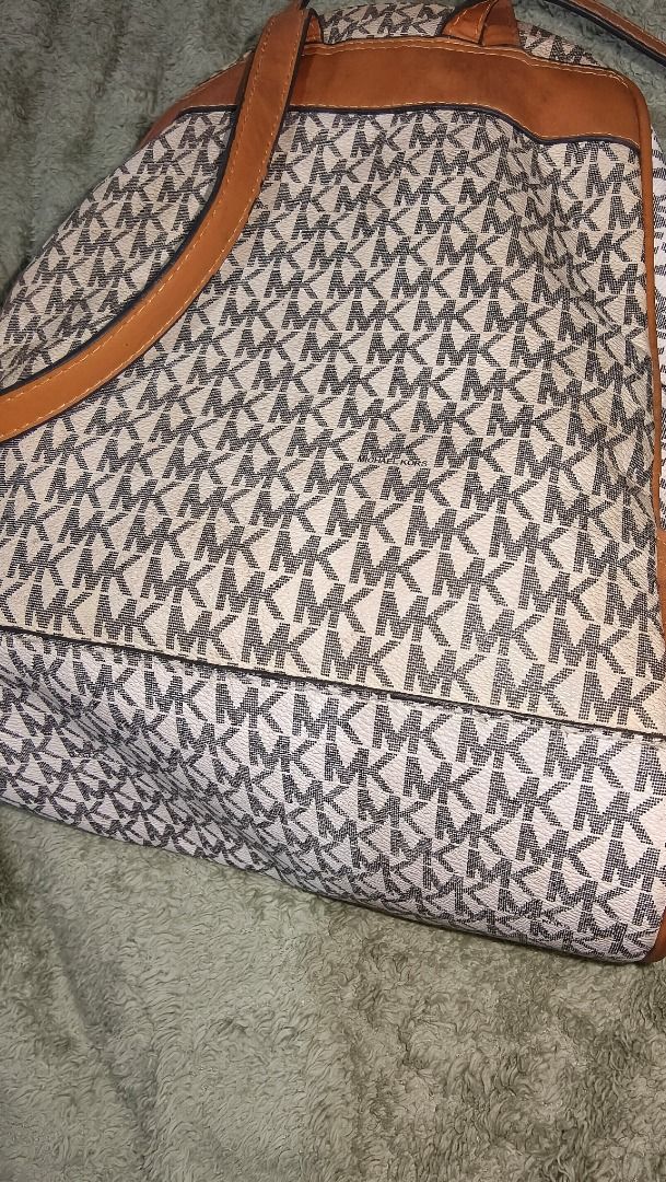 Michael Kors MK Monogram Backpack White Brown (Category: Backpacks) located in Caloocan City. Submitted by warmfox_1bc5f2 (Listing ID 1467686648, Image 2). Description: Slightly discoloration on the back of bag, it can be removed but idrk how. .
