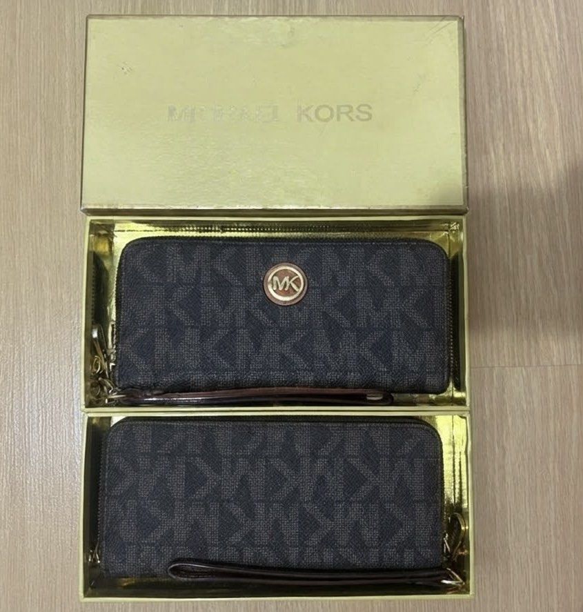 Michael Kors MK Monogram Wristlet Wallet Set (Category: Luxury Bags & Wallets) located in Manila. Submitted by everythingelse22 (Listing ID 1467784352, Image 1). Description: - Michael Kors wristlet wallets in the classic dark brown MK monogram print. -include wrist straps and zip-around closures. -The wallet has a circular MK logo plaque on the front. .
