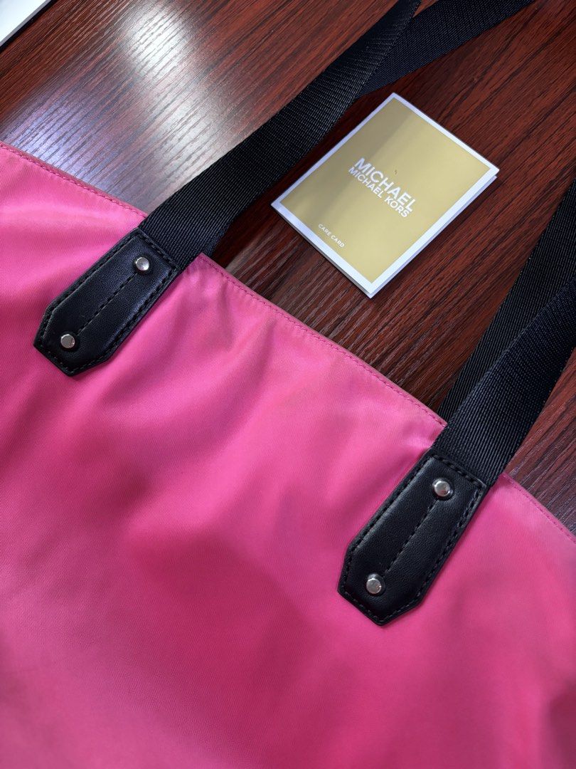 Michael Kors pink tote bag 💗 (Category: Luxury Bags & Wallets) located in Manila. Submitted by prlovedstff (Listing ID 1467816984, Image 3). Description: Pre-loved, still in good condition. Spacious and perfect for everyday use. With front zipper pocket and black handles. Included din yung MK tag sa pictures. PM for more details or pictures. 😊 .