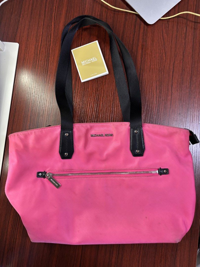 Michael Kors pink tote bag 💗 (Category: Luxury Bags & Wallets) located in Manila. Submitted by prlovedstff (Listing ID 1467816984, Image 1). Description: Pre-loved, still in good condition. Spacious and perfect for everyday use. With front zipper pocket and black handles. Included din yung MK tag sa pictures. PM for more details or pictures. 😊 .