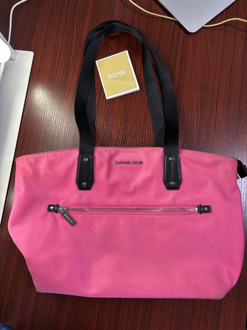 Michael Kors pink tote bag 💗 (Category: Luxury Bags & Wallets) located in Manila. Submitted by prlovedstff (Listing ID 1467816984, Image 2). Description: Pre-loved, still in good condition. Spacious and perfect for everyday use. With front zipper pocket and black handles. Included din yung MK tag sa pictures. PM for more details or pictures. 😊 .
