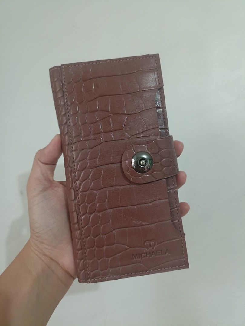 MICHAELA Crocodile Texture Long Wallet (Category: Wallets & Card holders) located in Las Pinas. Submitted by lovedbyazianh (Listing ID 1467729825, Image 1). Description: MICHAELA long wallet. Textured faux crocodile finish all over with a snap button closure. Inside has plenty of card slots and a clear ID window. Clean lining, nice structured shape..