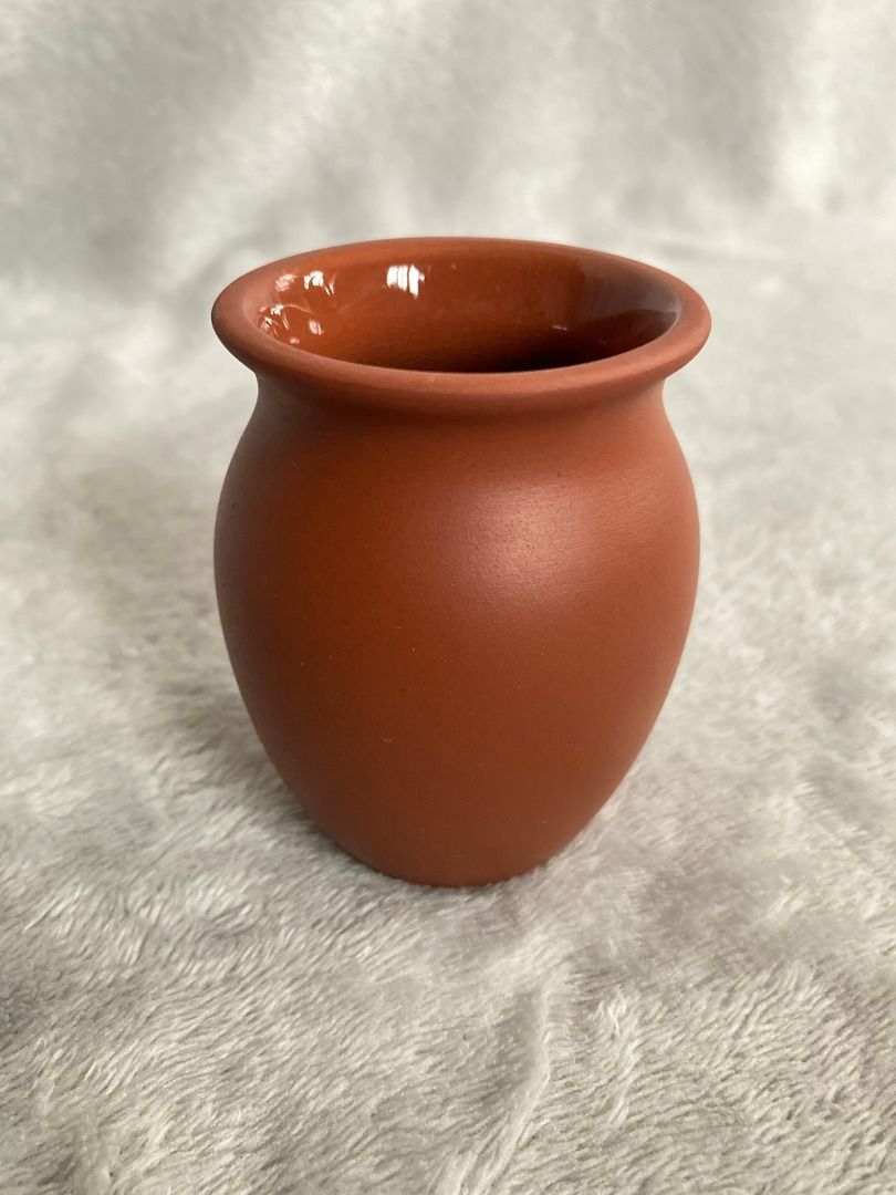 Mini terracotta pot small ceramic vase (Category: Vases & Decorative Bowls) located in Rizal. Submitted by sheeraay (Listing ID 1467704073, Image 1). Description: - Material: Reddish-brown terracotta clay with a smooth glazed interior - Size: Palm-sized, lightweight mini planter - Design: Classic rounded body with a flared rim - Condition: Clean inside and out - Ideal for: Tiny desk plants, succulents, or small props.