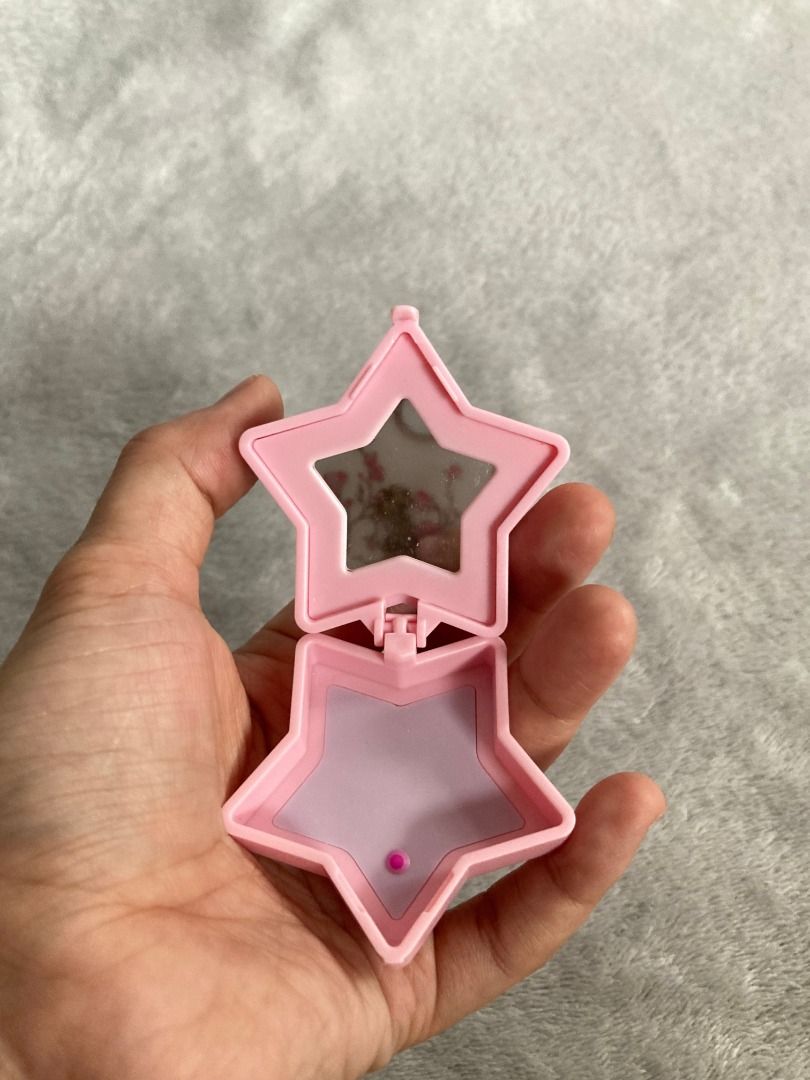 Mini toy containers (Category: Designer & Blind Box Toys) located in Rizal. Submitted by sheeraay (Listing ID 1467704357, Image 3). Description: - Design: Star-shaped pink plastic compact mirror with a secure button fastener - Interior: Features a small mirror on top and a smooth purple base - Portability: Lightweight and pocket-sized, ideal for travel and quick touch-ups - Condition: Clean, well-maintained, and opens/closes smoothly.