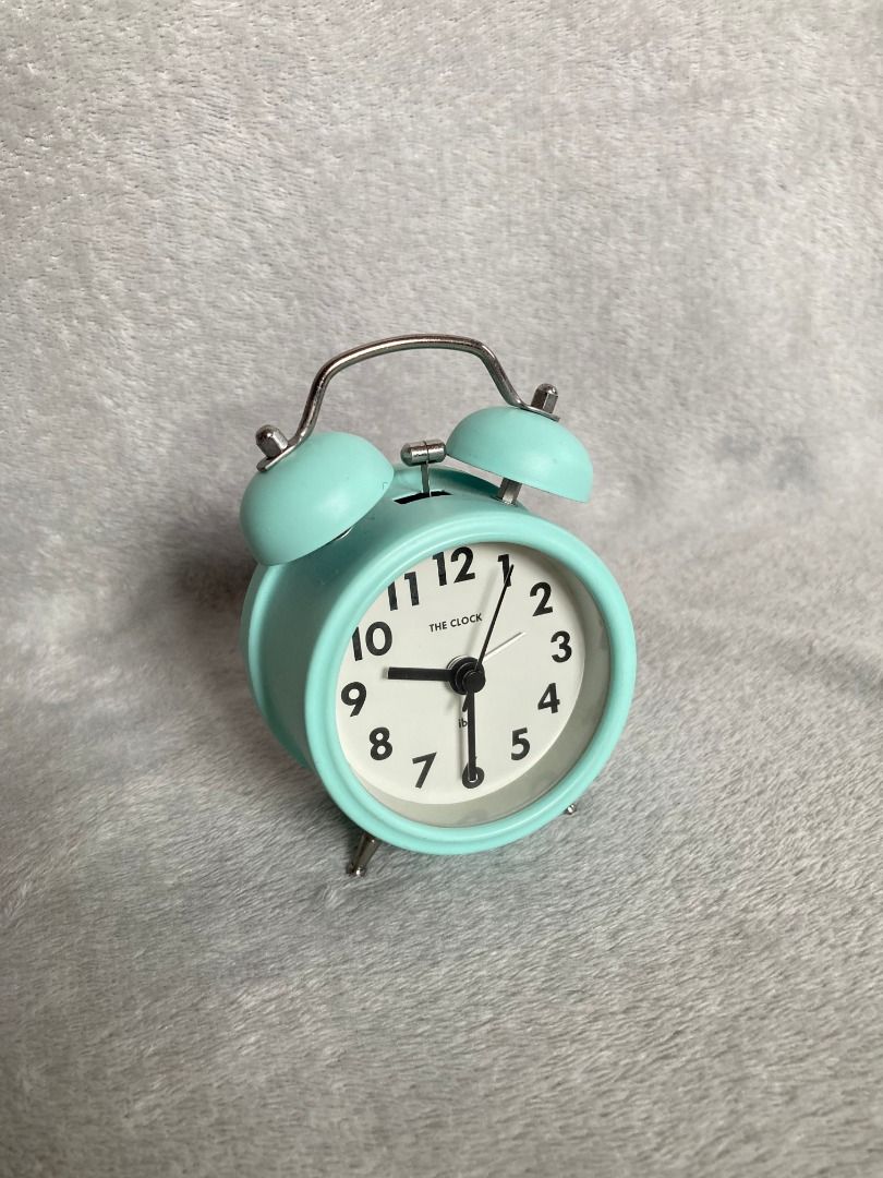 Mint green twin bell analog alarm clock (Category: Clocks) located in Rizal. Submitted by sheeraay (Listing ID 1467707310, Image 2). Description: - Color: Mint green with stylish silver accents - Design: Classic retro twin bell style - Display: White clock face with clear black numbers and hands - Alarm: Extra loud mechanical bell function to wake you up easily - Size: Compact and space-saving, ideal for bedside tables or desks - Power: Battery-o