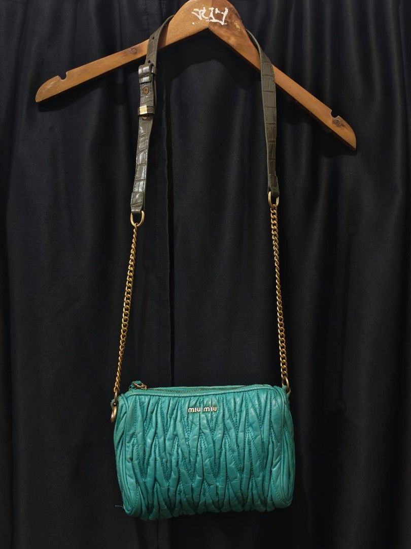 Miu Miu Quilted Teal Leather Crossbody Bag (Category: Cross-body Bags) located in Baguio. Submitted by solo_ukay (Listing ID 1467787708, Image 1). Description: - Brand: Miu Miu - Color: Gorgeous teal quilted leather with dark green leather shoulder section - Hardware: Premium gold-tone metal hardware - Strap: Chic combination chain and leather shoulder strap - Closure: Secure zipper featuring a charming small bow on the pull - Interior: Dark fabr