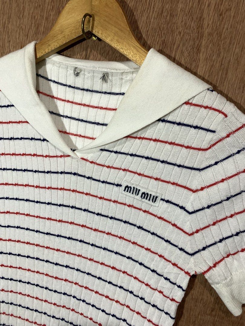 Miu Miu Striped Sailor Collar Knit Top (Category: Blouses) located in Tacurong. Submitted by ljsthrift (Listing ID 1467603205, Image 3). Description: - Brand: Miu Miu - Style: White knit top with red and blue horizontal stripes - Details: Sailor collar, V-neckline, embroidered brand logo patch on chest, ribbed hem and cuffs - Sleeves: Short sleeves - Interior Tag Code: AMAS 2020 1733 MMF441 1YVO - Condition: Excellent, well-maintained .