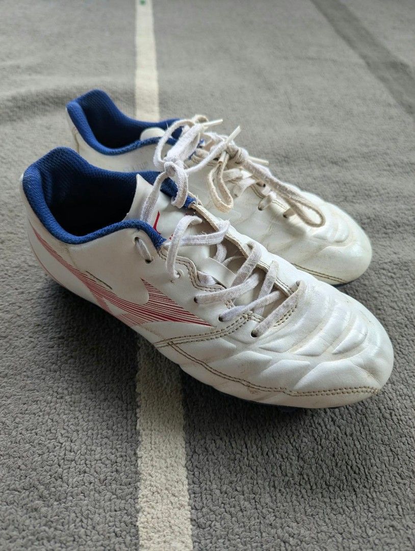 Mizuno Rebula Cup eu36 (Category: Sneakers) located in Bacolod City. Submitted by closetcleanupbcd (Listing ID 1467635148, Image 1). Description: - Brand: Mizuno soccer boots - Color: White with blue lining and red branding details - Tech: FT Grip upper technology for better ball control - Condition: Minor dirt marks and scuffs from pitch use; soles and studs are still 100% intact - Inclusions: Original white laces - Best for: Training sessions o