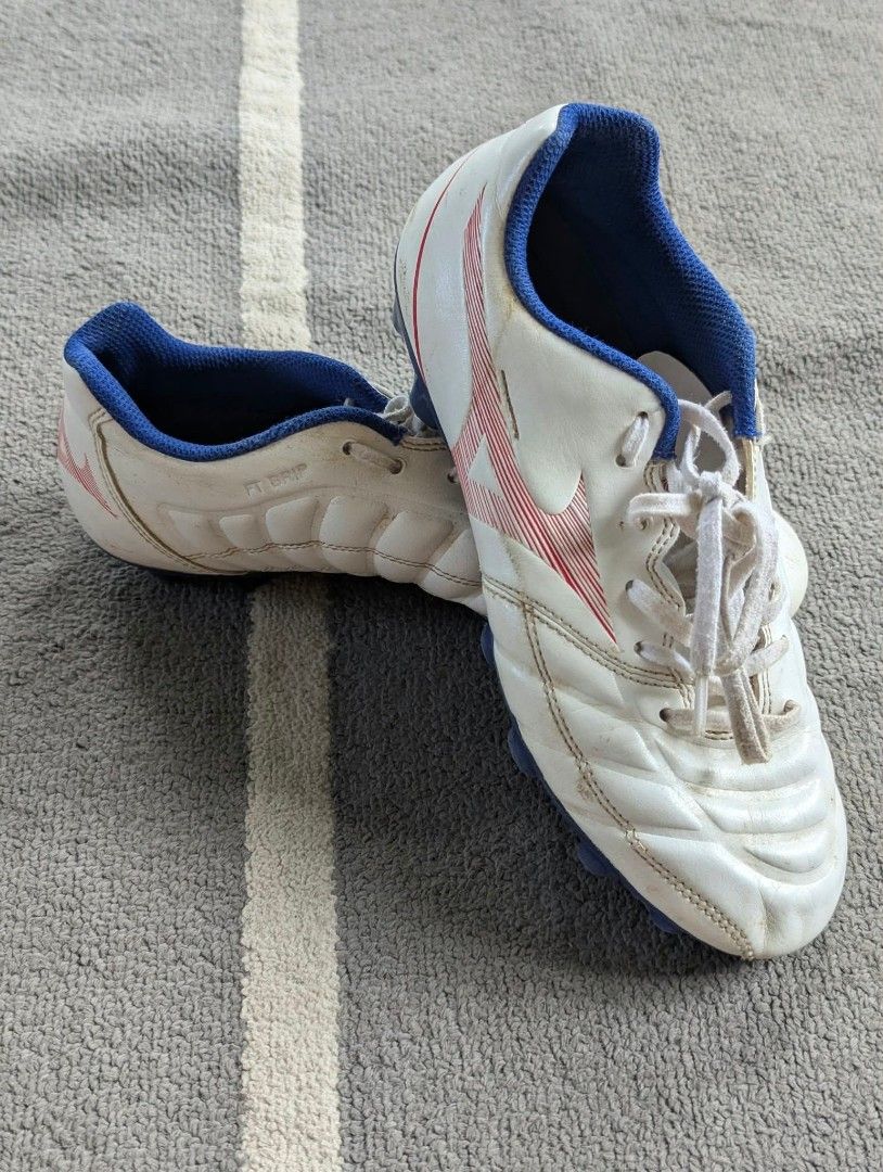 Mizuno Rebula Cup eu36 (Category: Sneakers) located in Bacolod City. Submitted by closetcleanupbcd (Listing ID 1467635148, Image 2). Description: - Brand: Mizuno soccer boots - Color: White with blue lining and red branding details - Tech: FT Grip upper technology for better ball control - Condition: Minor dirt marks and scuffs from pitch use; soles and studs are still 100% intact - Inclusions: Original white laces - Best for: Training sessions o