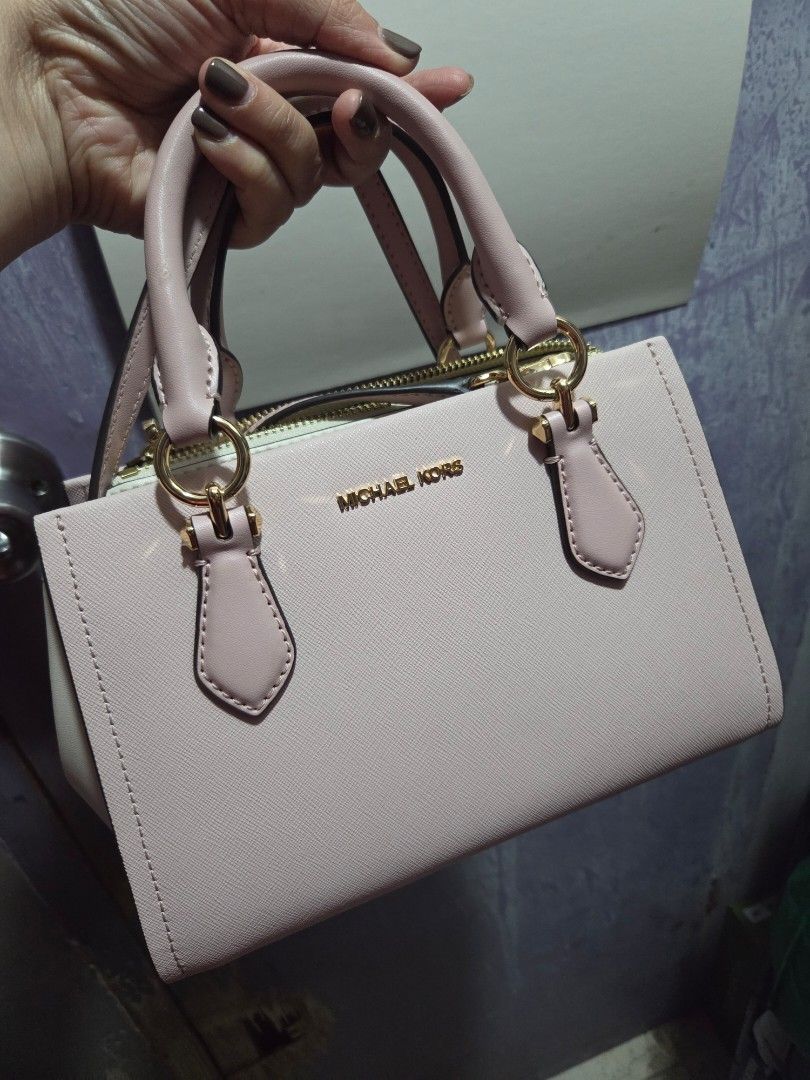 MK Marilyn Sling Bag Two Way (Category: Cross-body Bags) located in Makati City. Submitted by ellabit4379213 (Listing ID 1467740825, Image 1). Description: - Brand/Model: Michael Kors Marilyn Sling Bag - Color: Pink - Design: Structured with top handles and a detachable strap - Hardware: Gold tone with secure zipper closure - Condition: Excellent, clean interior and exterior.