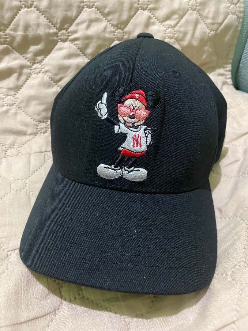 MLB x Disney Mickey Mouse Black Baseball Cap (Category: Caps & Hats) located in Quezon City. Submitted by elihur.tuazon (Listing ID 1467809101, Image 1). Description: Black baseball cap featuring embroidered Mickey Mouse graphic wearing red sunglasses and NY shirt on the front. Classic embroidered New Era Yankees logo on the side. Curved brim and structured panels. Clean surface, no noticeable flaws or stains..
