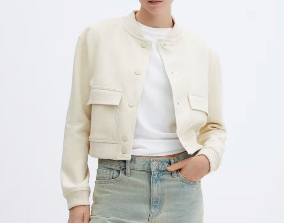 MNG Mango Cream Crop Bomber Jacket (Category: Coats, Jackets and Outerwear) located in Manila. Submitted by southie5 (Listing ID 1467626067, Image 1). Description: - Brand: MNG - Size: XS - Color: Cream - Style: Crop bomber jacket with snap button closure - Details: Two front flap pockets, ribbed knit collar, cuffs, and hem - Origin: Made in Bangladesh - Condition: Comfort and easy to style with jeans or casual outfits.