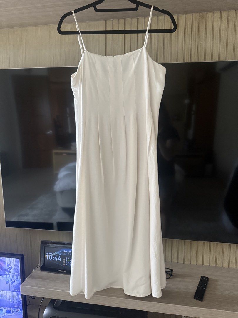 MNG White Spaghetti Strap Midi Dress (Category: Dresses) located in Antipolo. Submitted by ibyangs_closet (Listing ID 1467620601, Image 1). Description: - Brand: MNG - Style: White midi dress with thin spaghetti straps - Details: Square neckline with vertical pleating down the front - Material: Lightweight fabric, made in India - Condition: Clean, from a smoke-free home - Perfect for warm weather and easy styling!.