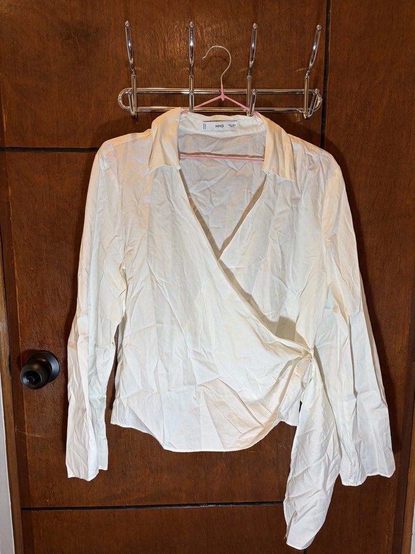 MNG White Wrap Blouse Long Sleeve (Category: Blouses) located in San Pedro. Submitted by tin.teodosio (Listing ID 1467724688, Image 1). Description: - Brand: MNG - Size: EU L/US 8 - Color: White - Design: Wrap front with side tie, collared neckline, and deep V-cut .