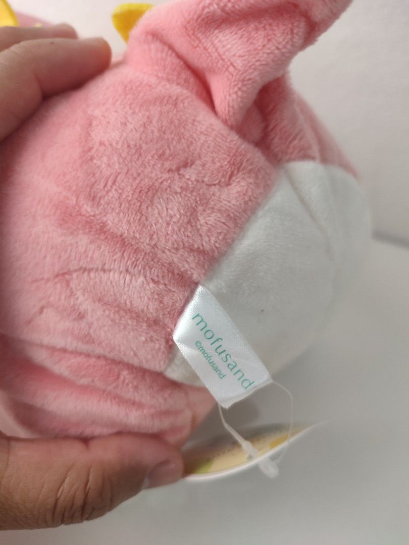 Mofusand Pink Dinosaur Cat Plush (Category: Plushies & Soft Toys) located in Manila. Submitted by epicmountain-f20453 (Listing ID 1467731647, Image 2). Description: - Authentic Mofusand cat plush wearing an adorable pink dinosaur costume - Super soft fabric with cute embroidered paw pads on hands and feet - Features a white belly, striking green eyes, a playful pink tongue, and yellow spikes on the back and tail - Perfect for gifts or Mofusand co