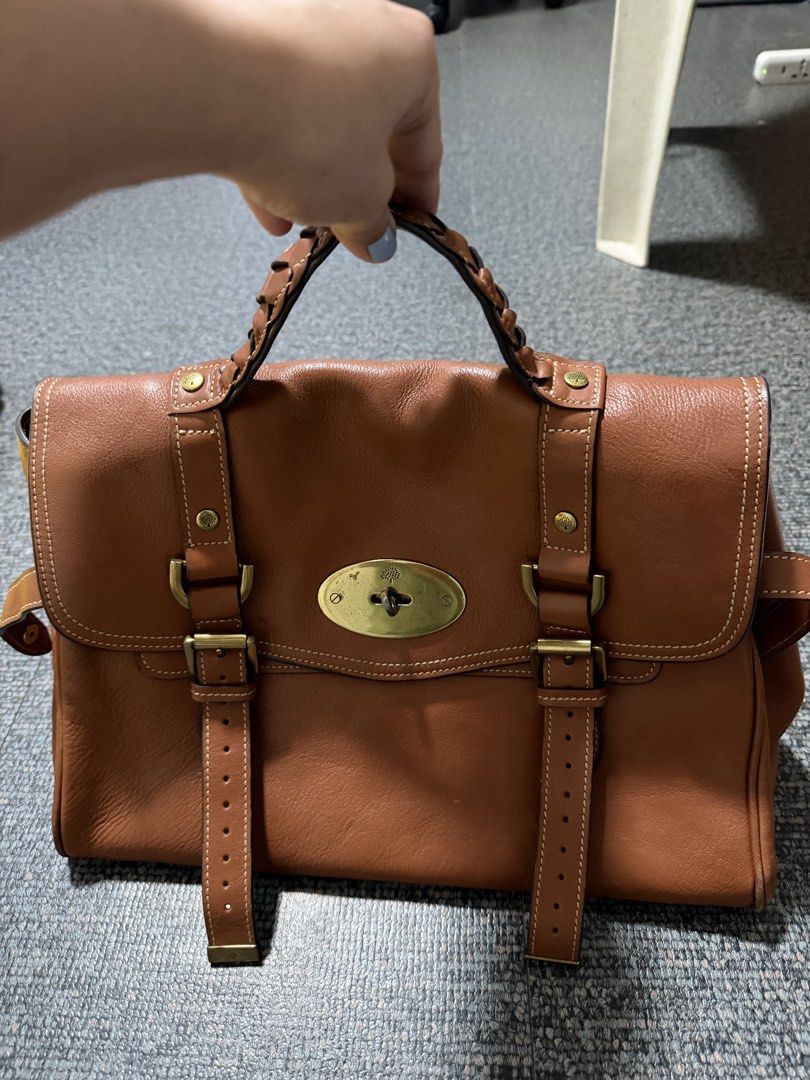 Mulberry Brown Leather Satchel Bag (Category: Luxury Bags & Wallets) located in Quezon City. Submitted by candyclosetph (Listing ID 1467754305, Image 3). Description: - Brand: Mulberry - Material: Rich brown leather with brass hardware - Design: Structured top handle, buckle strap details, and signature tree logo turn-lock closure - Interior: Spacious compartment with side gussets - Condition: Normal signs of wear on hardware and leather edges - 