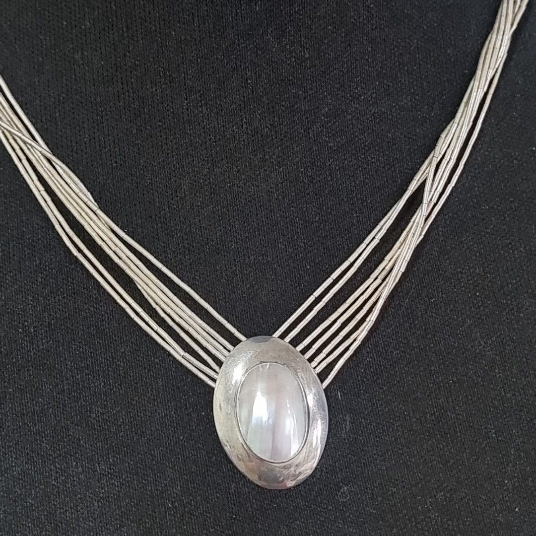 Multi-strand Necklace with Pearl Pendant (Category: Necklaces) located in Pasig City. Submitted by lesmitch (Listing ID 1467645310, Image 2). Description: - Multi-strand silver beaded design with tube beads - Features a smooth oval pendant with pearl stone - Vintage-inspired style that sits close to the collarbone - Length: 20 inc. ~ Check all photos for the item's actual condition and measurements ~ Payment is via gcash, pay maya or bdo ~ Shippi