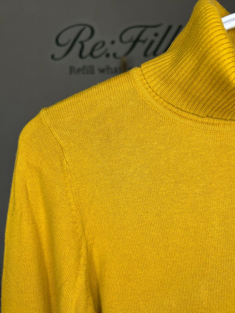 Mustard Yellow Turtleneck Sweater (Category: Longsleeves) located in Taguig. Submitted by re.wear.mnl (Listing ID 1467702481, Image 3). Description: - Brand: XXI - Size: Fits S-M, 21.5 x 17 inches - Color: Mustard yellow - Style: Turtleneck pullover with long sleeves - Details: Soft knit fabric, ribbed cuffs and hem, adorable polka dot bow accent inside the collar - Condition: Clean with minimal signs of wear.