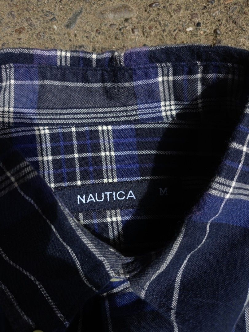 Nautica Blue Plaid Long Sleeve Button-Down Shirt (Category: Formal Shirts) located in Caloocan City. Submitted by reymartthrift (Listing ID 1467636719, Image 2). Description: - Brand: Nautica - Design: Blue, navy, and white plaid pattern - Style: Long sleeve button-down with classic collar and curved hem - Details: Single chest pocket with embroidered Nautica logo - Fit: Standard fit, great for casual days or layering - Condition: Excellent pre-l