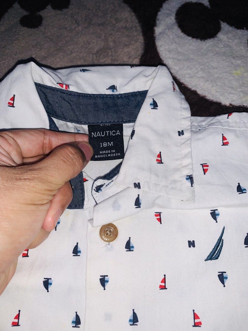Nautica Polo Longsleeve (Category: Babies & Kids Fashion) located in Pasig City. Submitted by nyca1989 (Listing ID 1467773260, Image 3). Description: White long-sleeve button-down infant shirt from Nautica in size 18M, featuring an all-over nautical print of red and blue sailboats and letter “N” accents..