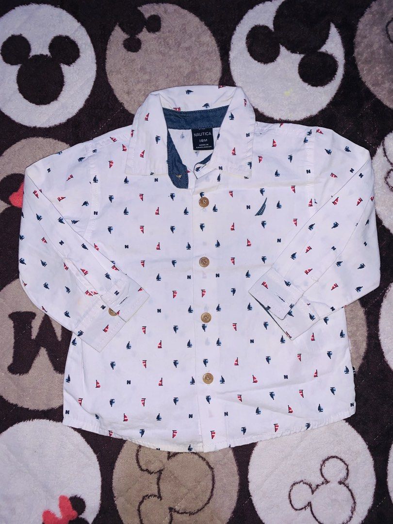 Nautica Polo Longsleeve (Category: Babies & Kids Fashion) located in Pasig City. Submitted by nyca1989 (Listing ID 1467773260, Image 1). Description: White long-sleeve button-down infant shirt from Nautica in size 18M, featuring an all-over nautical print of red and blue sailboats and letter “N” accents..