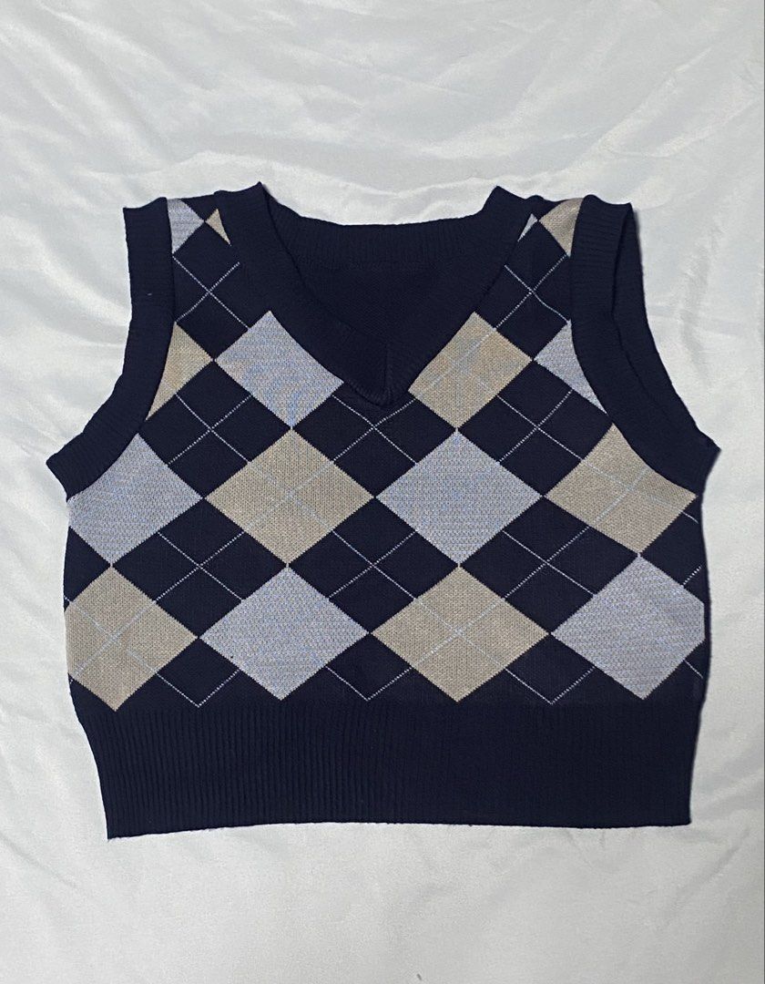 Navy Blue Argyle V-Neck Knit Sweater Vest (Category: Coats, Jackets and Outerwear) located in Paranaque City. Submitted by pomeloluvr (Listing ID 1467679653, Image 1). Description: - Color: Dark navy blue with light blue and beige argyle pattern - Design: Classic V-neck, ribbed hem, and solid plain navy back - Material: Soft and comfortable knit fabric - Styling: Perfect for layering over button-up shirts or wearing on its own - Condition: Excell
