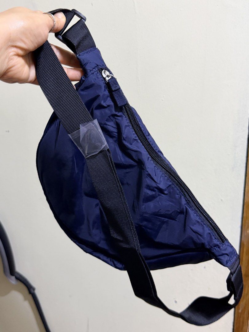 Navy Blue Crescent Nylon Sling Bag (Category: Cross-body Bags) located in Paete. Submitted by skydruemadison (Listing ID 1467719997, Image 2). Description: - Color: Navy blue - Material: Lightweight nylon - Style: Trendy crescent shape with smooth curved zipper - Strap: Adjustable black strap (still wrapped in protective plastic) - Capacity: Roomy main compartment, easily fits phone, wallet, and keys - Use: Great for daily errands and hands-free 