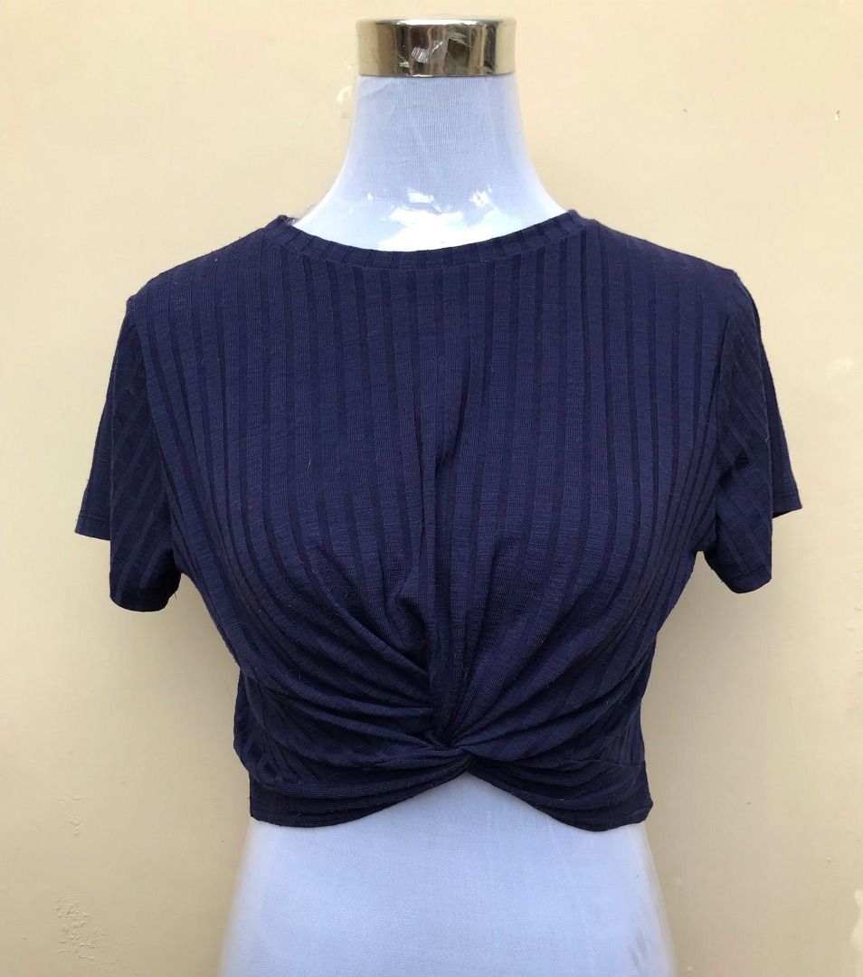 Navy Blue Ribbed Twist Front Crop Top (Category: Sleeveless) located in Quezon City. Submitted by ezrakeith (Listing ID 1467806689, Image 1). Description: - Color: Dark blue - Material: Soft ribbed knit with great stretch - Design: Front twist hem detail, classic round neckline, and short sleeves - Fit: Crop top style, ideal for pairing with high-waisted jeans or skirts.