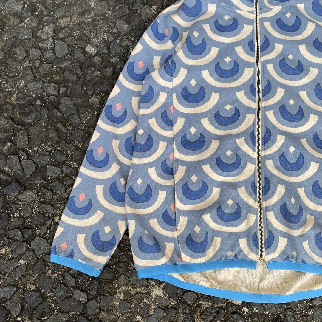 Ne-net Zip Up Scale Hoodie (Category: Coats, Jackets and Outerwear) located in Quezon City. Submitted by rebirthalley (Listing ID 1467695091, Image 3). Description: This is a blue zip-up hoodie featuring an all-over geometric scallop or carp streamer ("koinobori") pattern from the Japanese brand Ne-net. Width-20.5 Length-25.5 Sleeve-21.5 Shoulder-18.5 Hem-19 Excellent Condition Need wash only.