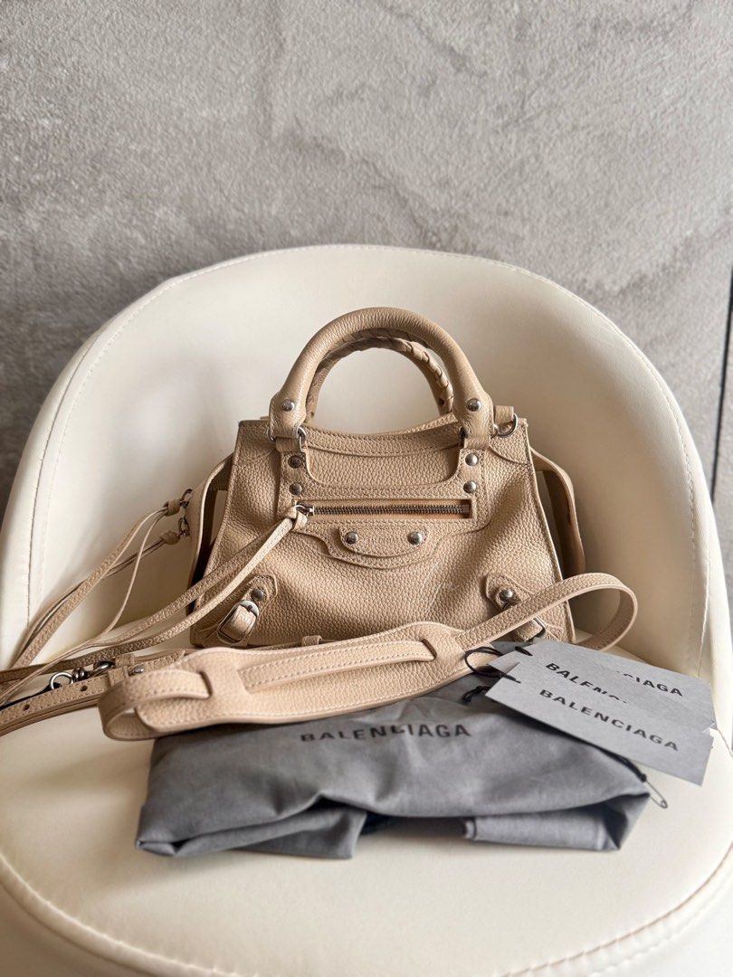 Neo Classic City Tote Bag (Category: Luxury Bags & Wallets) located in Bacoor. Submitted by iammommylyn (Listing ID 1467745838, Image 1). Description: ON HAND & READY TO SHIP. Pre-loved Neo Classic City Bag Mini in Grained Calfskin Leather. Beige color. ✔️Rank: A, signs of usage ✔️Material: grained calfskin leather ✔️Inclusion: dustbag, authenticity card, detachable shoulder strap ✔️Origin: Italy ✔️Dimensions: 21cm (h) x 33cm (w) x 14cm (d); hand