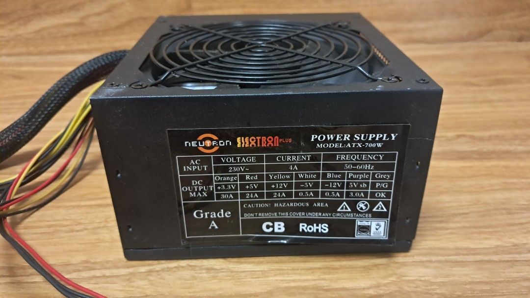 Neutron Electron Plus ATX-700W Power Supply Unit (Category: Computer Parts) located in Trece Martires City. Submitted by kgbph (Listing ID 1467683637, Image 1). Description: Neutron Electron Plus ATX 700W Power Supply Unit in clean, working condition. Features a black casing with a top fan guard and attached standard cables. Reliable choice for standard PC builds..