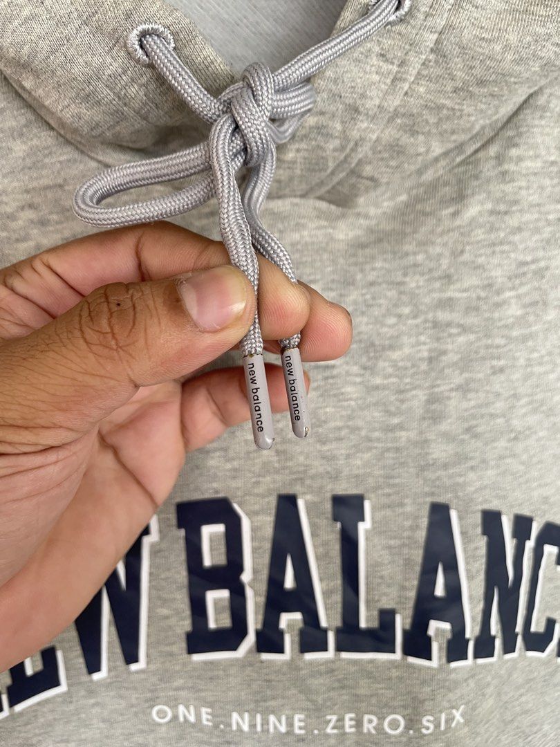 New Balance graphic pullover hoodie (Category: Coats, Jackets and Outerwear) located in Manila. Submitted by oftherack_04 (Listing ID 1467626833, Image 3). Description: New Balance graphic pullover hoodie featuring a collegiate-style arched logo and “ONE. NINE. ZERO. SIX.” text detail across the chest. Excellent condition No issue Size Large .