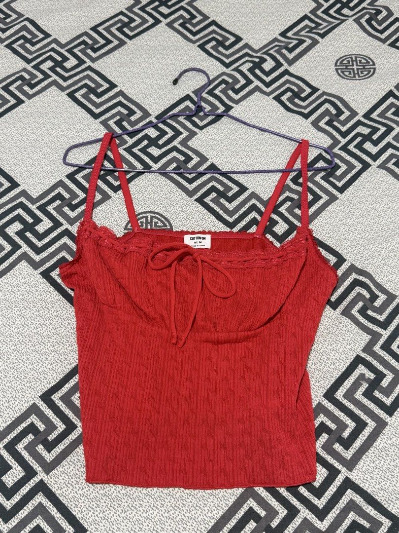 NEW Cotton On Red Tops Bundle Size M (Category: Sleeveless) located in Valenzuela. Submitted by ellapsl (Listing ID 1467726297, Image 3). Description: - Brand: Cotton On - Size: Medium (M) - Quantity: Set of 2 red tops - Piece 1: Spaghetti strap cami with tie-front string and delicate lace trim - Piece 2: Halter neck top featuring an all-over eyelet diamond pattern - Condition: Brand new with clear brand tags attached inside - Style: Versatile wa