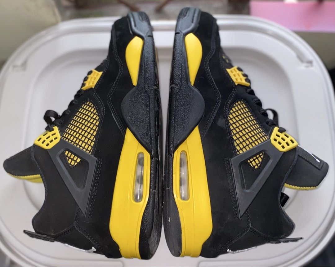 Nike Air Jordan 4 Thunder Black Yellow (Category: Sneakers) located in Baguio. Submitted by bruddafunk420 (Listing ID 1467782552, Image 2). Description: - Model: Air Jordan 4 - Colorway: Iconic Black and Yellow - Material: Premium nubuck upper with bright yellow eyelets, midsole, and netting - Branding: Classic Jumpman logo on the tongue and heel - Soles: Clean rubber outsoles with visible air cushioning units - Condition: Pre-owned with minor sc