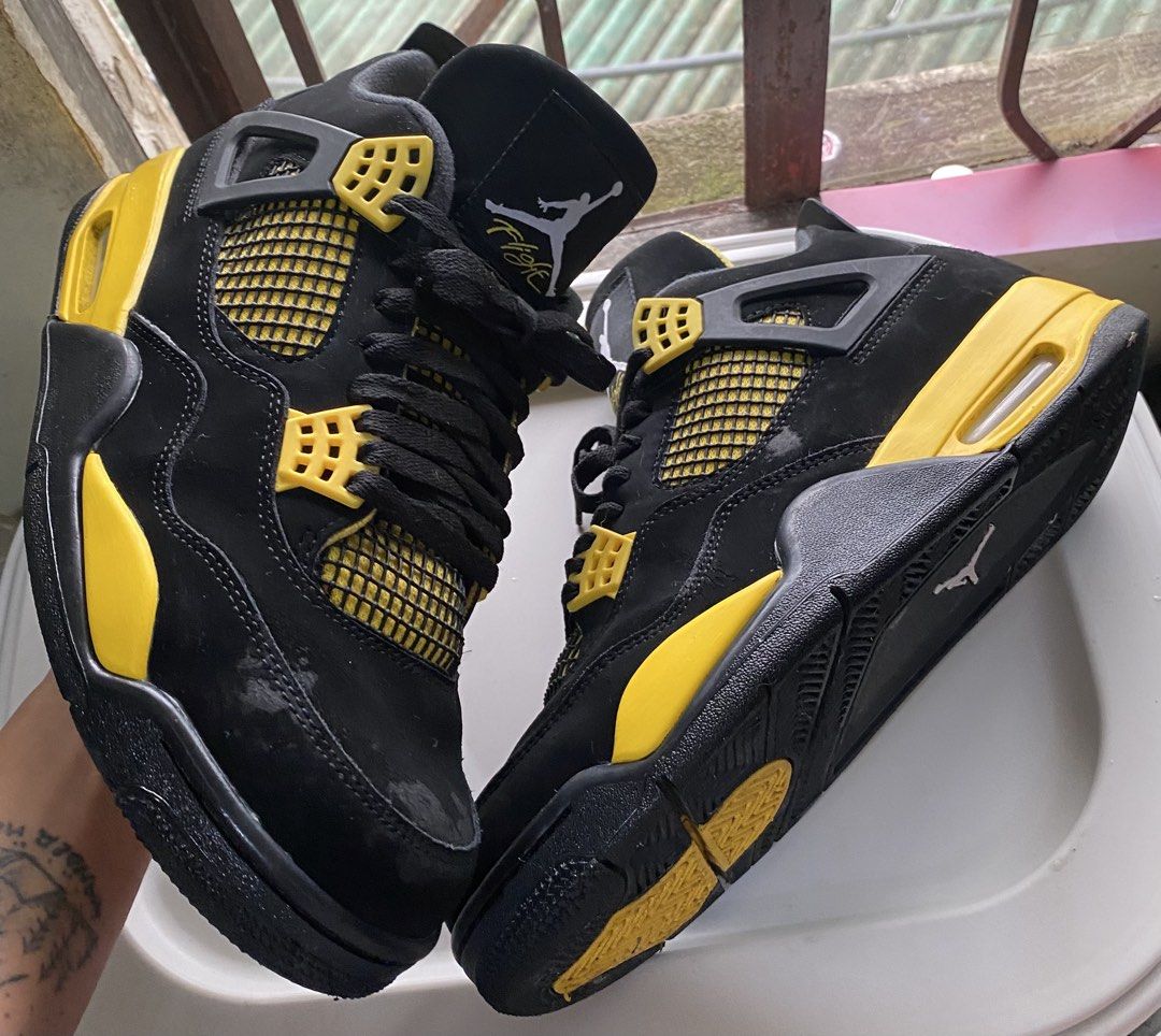 Nike Air Jordan 4 Thunder Black Yellow (Category: Sneakers) located in Baguio. Submitted by bruddafunk420 (Listing ID 1467782552, Image 1). Description: - Model: Air Jordan 4 - Colorway: Iconic Black and Yellow - Material: Premium nubuck upper with bright yellow eyelets, midsole, and netting - Branding: Classic Jumpman logo on the tongue and heel - Soles: Clean rubber outsoles with visible air cushioning units - Condition: Pre-owned with minor sc