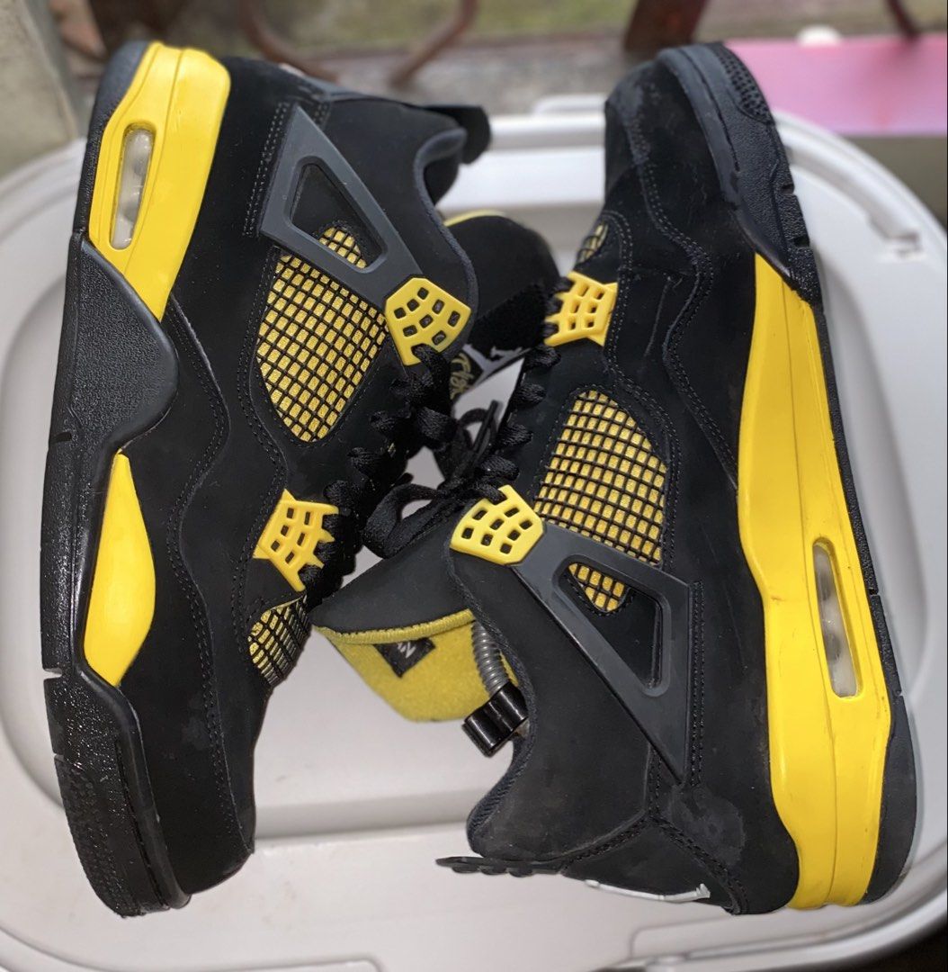 Nike Air Jordan 4 Thunder Black Yellow (Category: Sneakers) located in Baguio. Submitted by bruddafunk420 (Listing ID 1467782552, Image 3). Description: - Model: Air Jordan 4 - Colorway: Iconic Black and Yellow - Material: Premium nubuck upper with bright yellow eyelets, midsole, and netting - Branding: Classic Jumpman logo on the tongue and heel - Soles: Clean rubber outsoles with visible air cushioning units - Condition: Pre-owned with minor sc