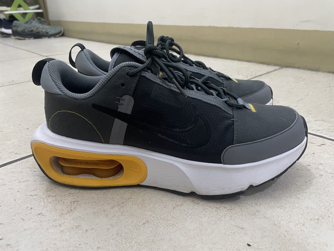 Nike Air Max Alpha Trainer 5 (Category: Sneakers) located in Manila. Submitted by kennethv (Listing ID 1467810057, Image 2). Description: - Brand/Model: Nike Air Max sneakers - Colorway: Grey, black, and white with striking yellow Air Max heel bubbles - Materials: Dark grey mesh upper with durable synthetic overlays and dark laces - Features: Heel pull tabs for easy on and off, standard rubber outsole - Condition: Minor signs of wear on the midso