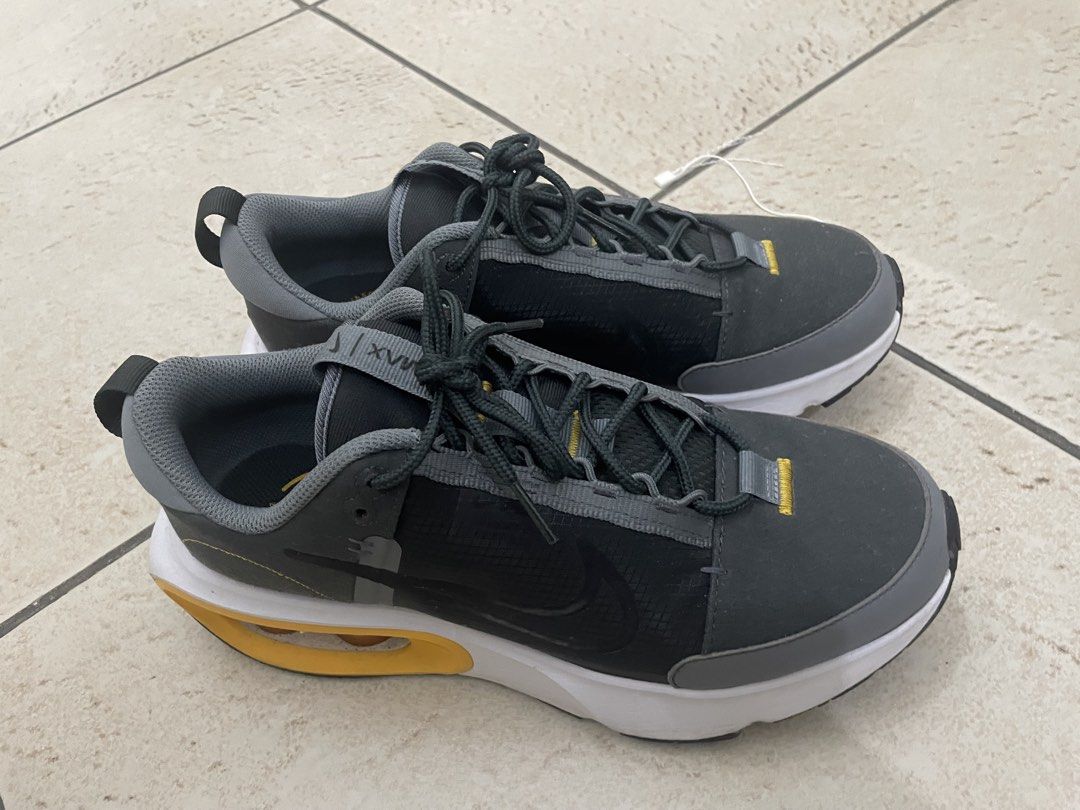 Nike Air Max Alpha Trainer 5 (Category: Sneakers) located in Manila. Submitted by kennethv (Listing ID 1467810057, Image 1). Description: - Brand/Model: Nike Air Max sneakers - Colorway: Grey, black, and white with striking yellow Air Max heel bubbles - Materials: Dark grey mesh upper with durable synthetic overlays and dark laces - Features: Heel pull tabs for easy on and off, standard rubber outsole - Condition: Minor signs of wear on the midso